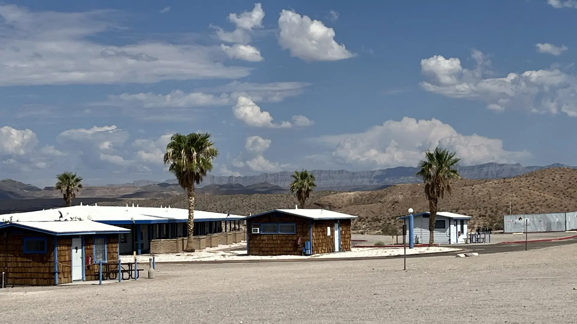 Temple Bar Motel cabins and palm trees under a desert sky